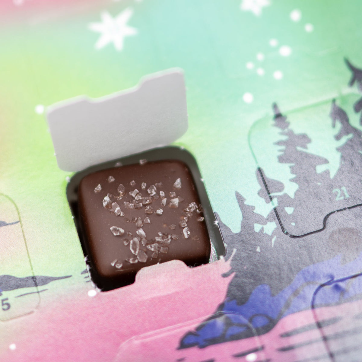 Chocolate bar with a white top and dark brown bottom on a colorful, abstract background
